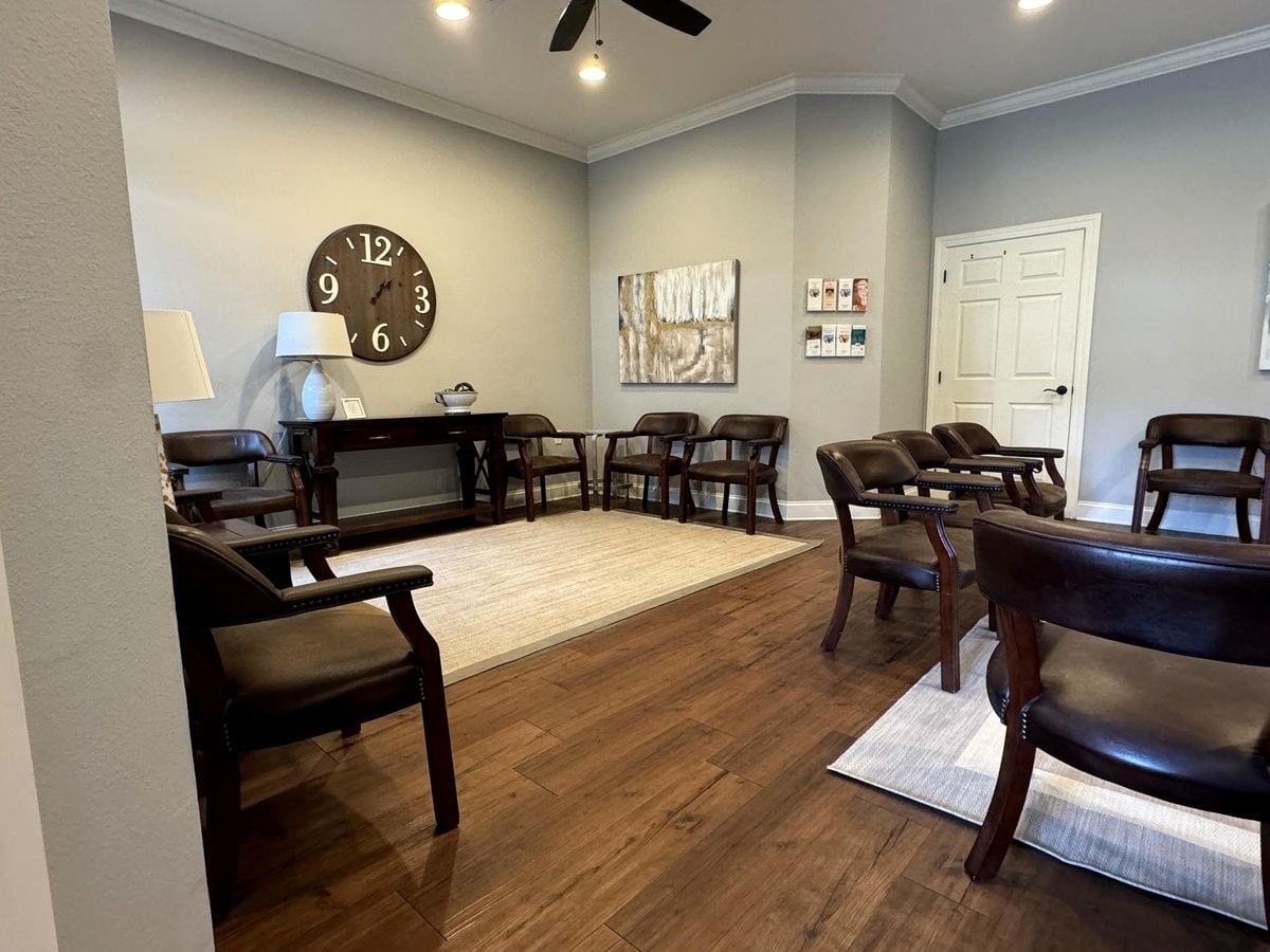 Comfortable seating and warm wood floors in the waiting room